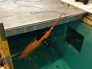 Seaglider hanging nose-down at the surface of a test tank