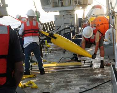 Carrying the recovered glider to its cart on deck